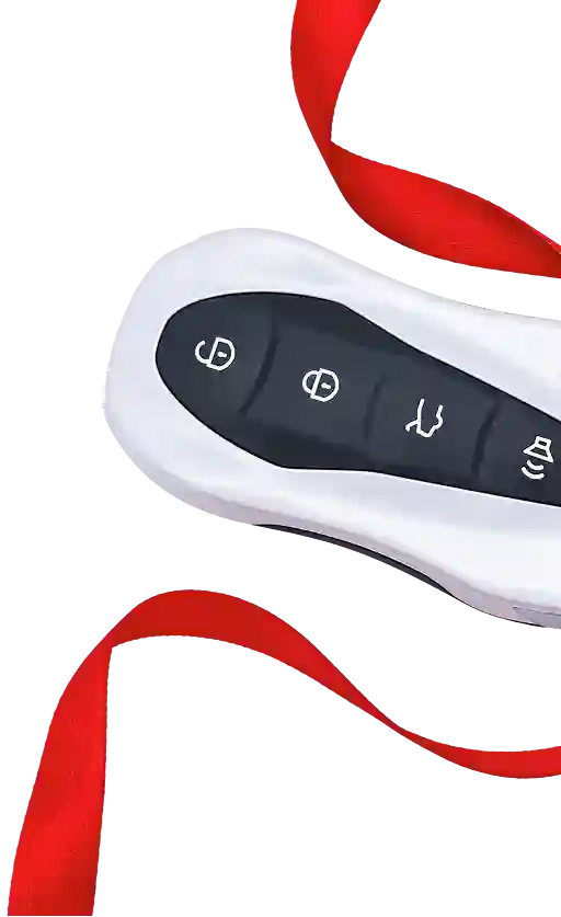 A close-up of a white car key fob with four black buttons and a red ribbon on a black background.